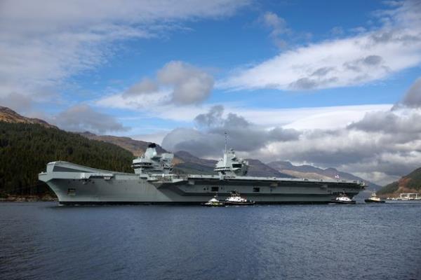 HMS Queen Elizabeth air craft carrier is pulled by tugs on Loch Long on March 18, 2024 in Glenmallan, Scotlan