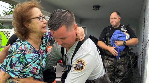 This photo provided by Venice Police Department rescue crews assist residents after  conducting door-to-door wellness checks, in coastal areas that were flooded by Hurricane Helene on Friday, Sept. 27, 2024 in Venice, Fla . (Venice Police Department via AP)